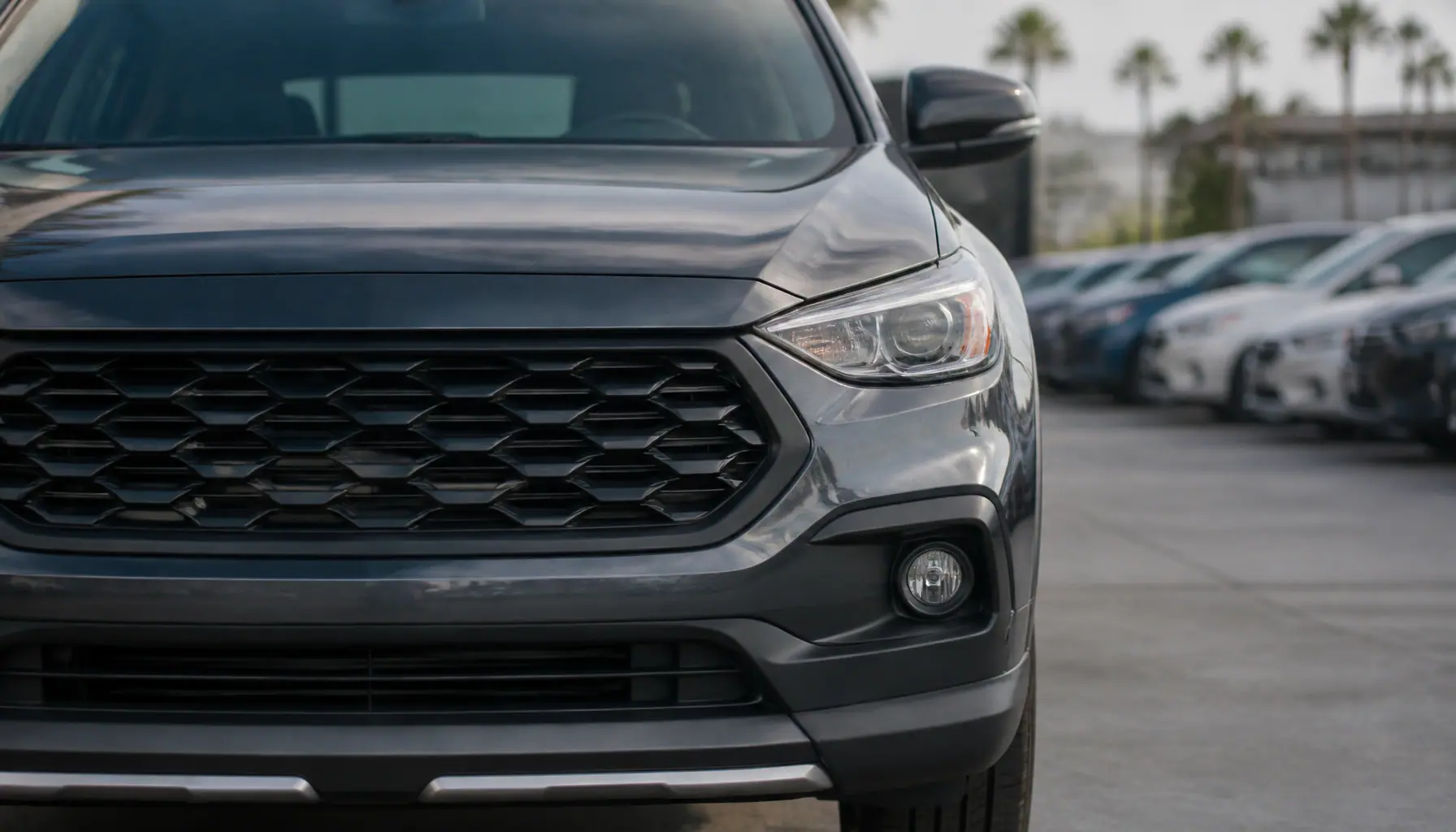 Used SUVs under $15,000 in Costa Mesa. front grille and headlight detail of a used vehicle on the You First Autos lot in Costa Mesa, CA